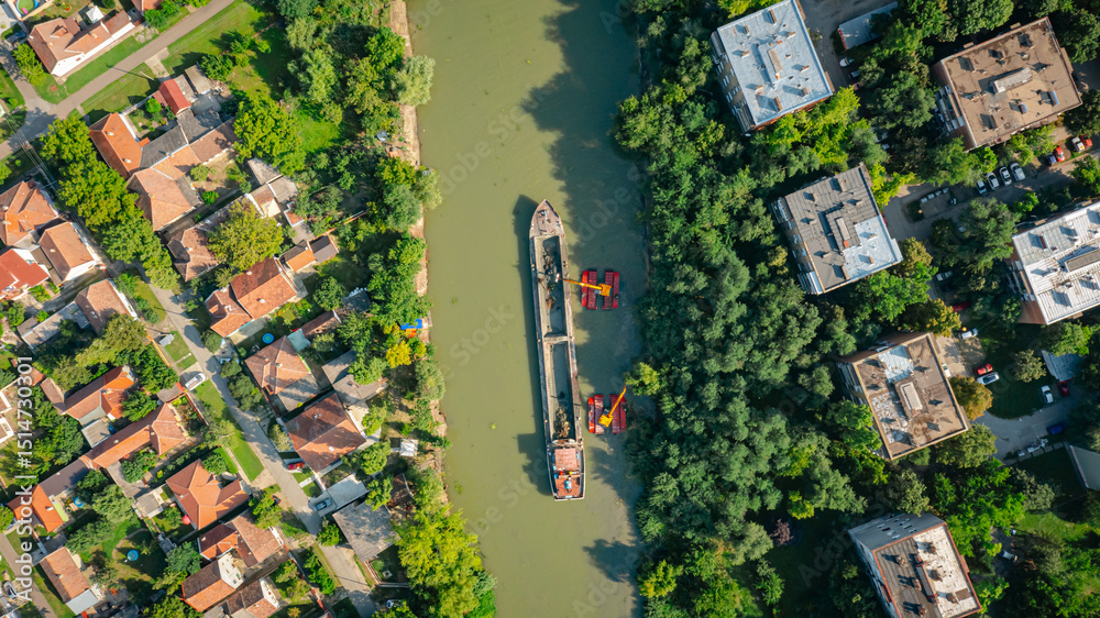Naklejka premium Aerial view of river, canal is being dredged by excavators