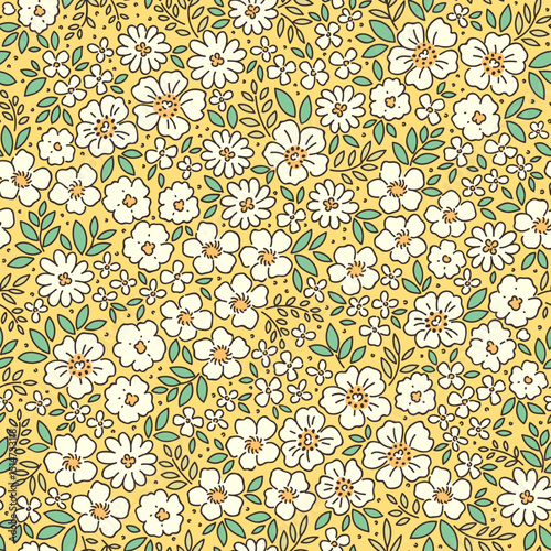 Retro floral pattern in small decorative flowers. Small white flowers. Green leaves. Light yellow background. Ditsy print. Floral seamless background ditsy pattern in small cute spring flowers.