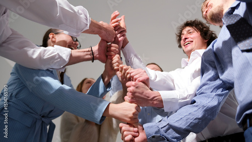 Young marketing professionals are playing a fun leadership development game. A group of people is standing in a circle