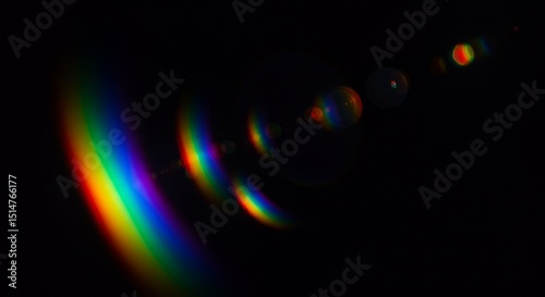 Abstract Rainbow Lens Flare Effect on Black Background Illustration
