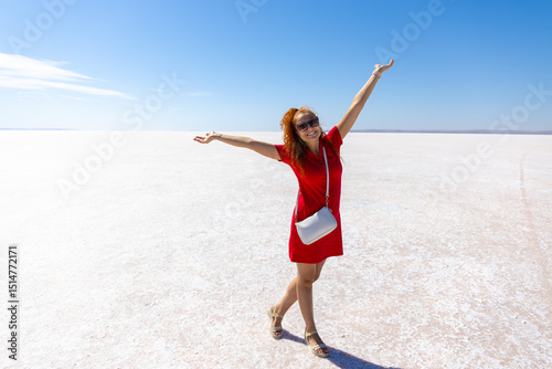 young woman in red dress in Salt lake Tuz, Turkey photo