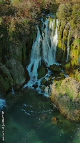 Aerial view of Kravica Waterfall in Bosnia and Herzegovina. Natural beauty in the Trebizat River. Vertical video
