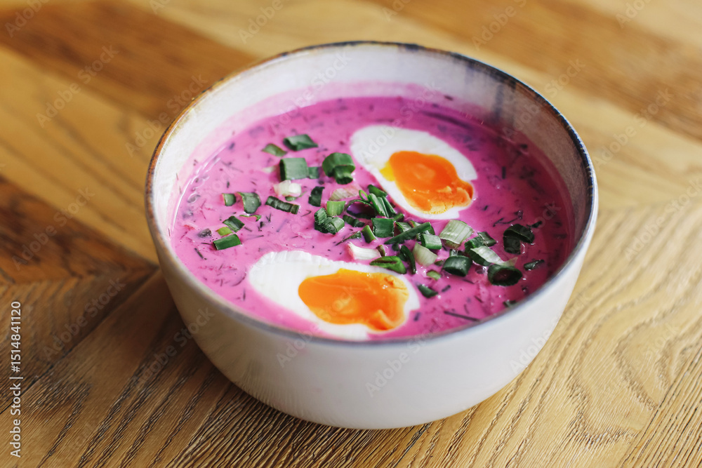 Traditional cold beet soup. Chilled summer dish with eggs. Pink creamy soup in bowl. Rustic wooden table. Fresh herbs topping. Healthy lunch idea. Polish cuisine concept. Chlodnik soup closeup. Traditional cold beet soup. Chilled summer dish with eggs. Pink creamy soup in bowl. Rustic wooden table. Fresh herbs topping. Healthy lunch idea. Polish cuisine concept. Chlodnik soup closeup.
