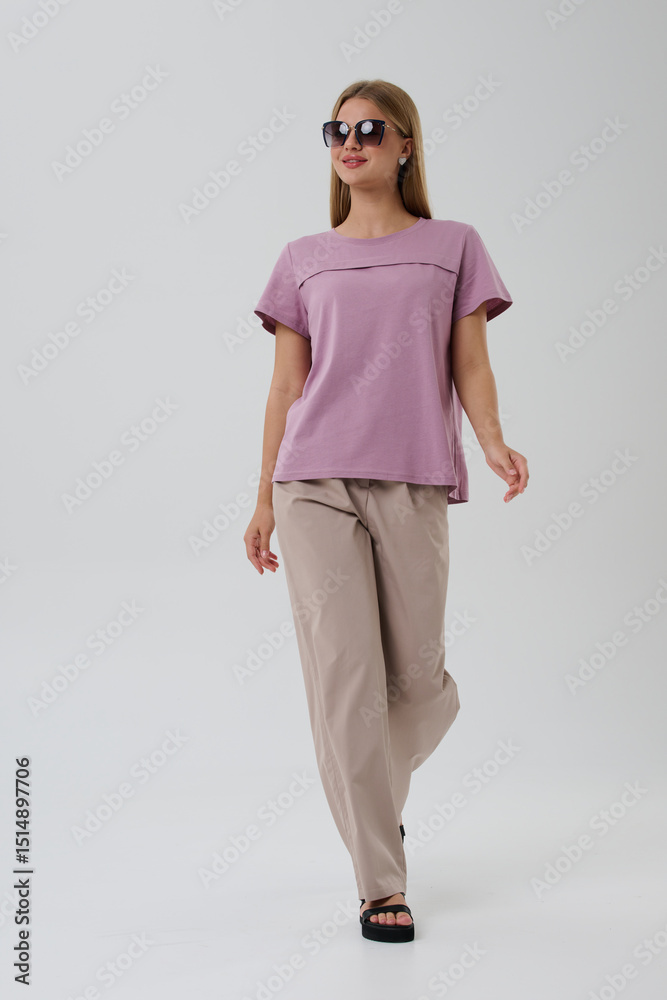Obraz premium Girl model in casual clothes on a gray background posing in the studio