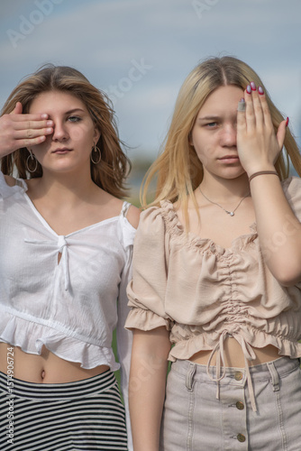 Portrait of two beautiful young girls friends in an urban environment.