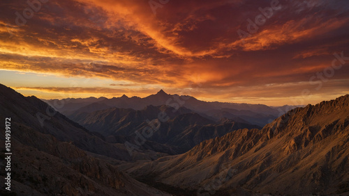 A dramatic red sky transitions into gold near the horizon where jagged mountain peaks form a silhouette, photographed from a wide-angle at base level to exaggerate the scale of the