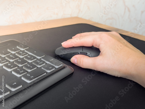 Image of female hand clicking computer mouse