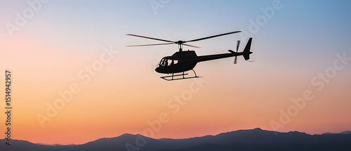 Helicopter Silhouette At Sunset Over Mountains