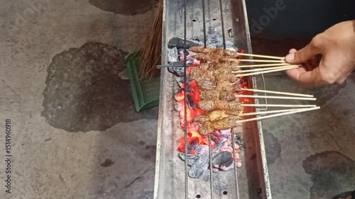Delicious hot chicken satay grilled on a brazier with charcoal
