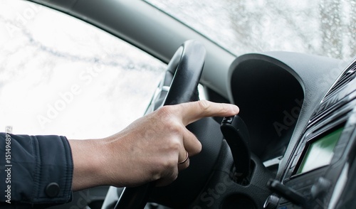 The driver's finger presses the mode control key of the route computer