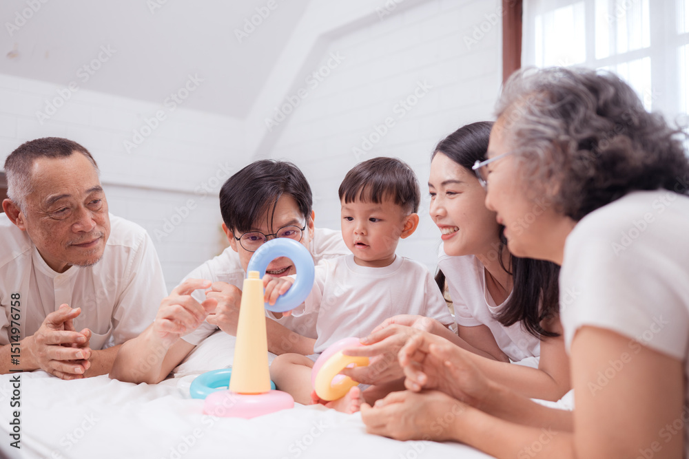 Fototapeta premium Before putting the kids to bed, parents, grandparents, and kid unwind and play in the bedroom