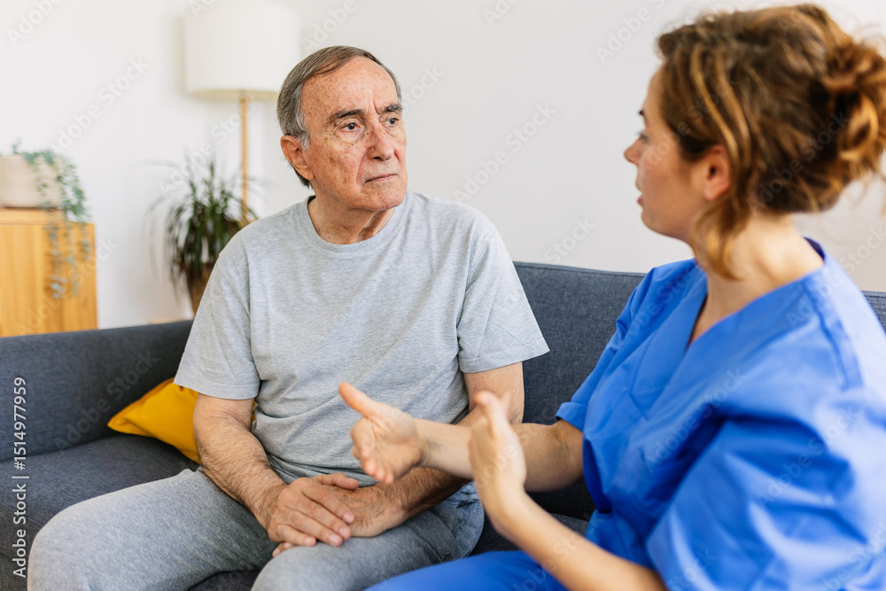Obraz premium Female caregiver talking with senior male patient at nursing home. Young doctor holding hands with old man on sofa, supporting, sitting together on sofa. Elderly healthcare and assistance concept.