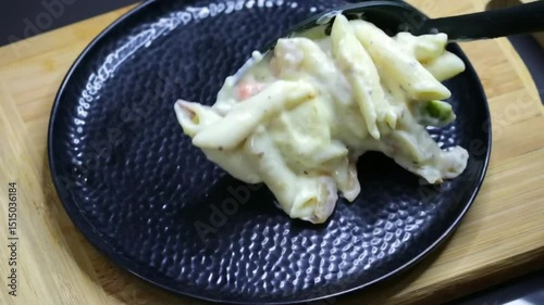 Penne pasta tossed in rich, creamy white sauce made with cheese and herbs, served as a comforting Italian meal, perfect for lunch, dinner, or restaurant-style dining experience.