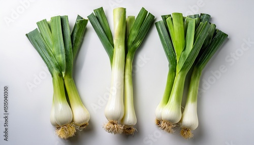 fresh leeks neatly arranged on a clean white backdrop for culinary photography