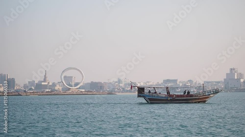 Qatar Doha 12 february 2025, Scenic dhow sailing on calm waters near city skyline
