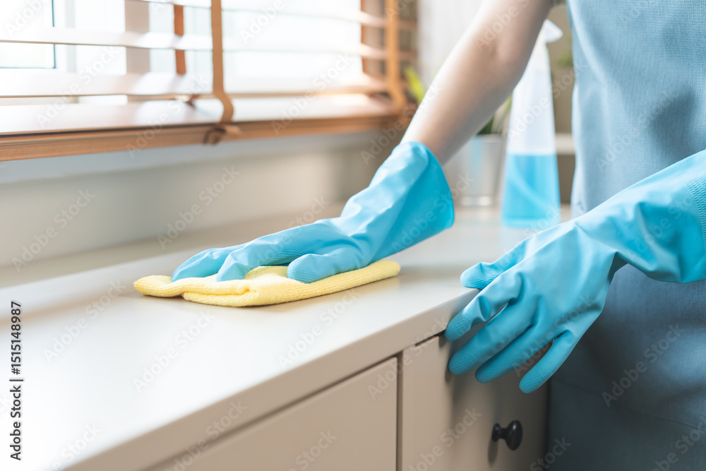 Φωτογραφία Cleanliness household asian young woman working chore cleaning on cupboard at home, hand wearing glove and using wiping with microfiber cloth remove dust in living room