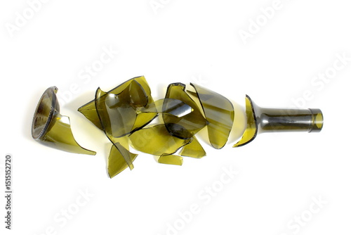 There is a broken green wine bottle lying on a white background.	 photo