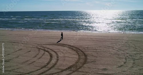 Embarking on a Solitary Walk Along a Serene Beach at Sunrise, Embracing Tranquility and Peace