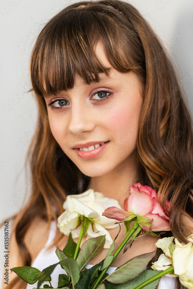 Little pretty girl in pink holds the bouquet of roses. Little pretty girl in pink holds the bouquet of roses.