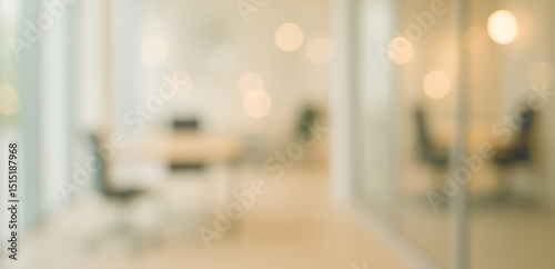 Warm-toned blurred office interior featuring soft lighting, glass walls, and a modern workspace layout, evoking a calm, productive, and professional environment. photo