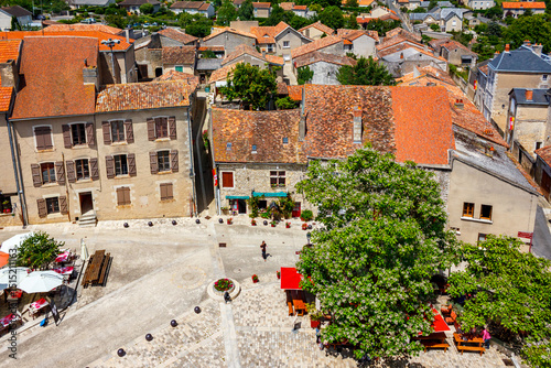 Chauvigny, France: picturesque little village with medieval architecture, elevated view from the dungeon, tourists on restaurant terrasses in central square, near Poitiers photo