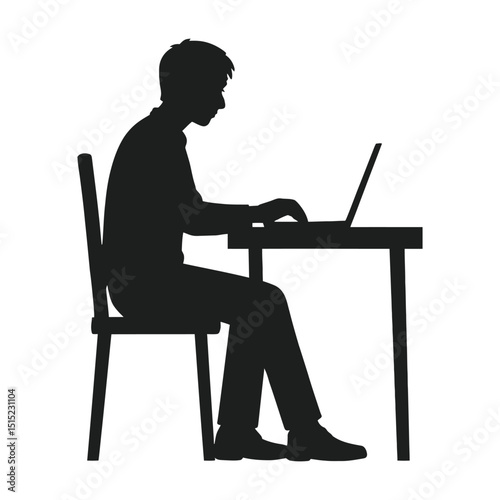 Silhouette of a man working on laptop computer at a desk