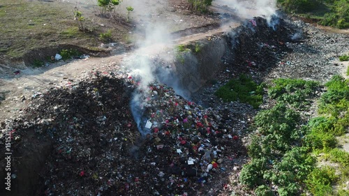 Burning dump, plastic pollution, industry drone view in Bali.