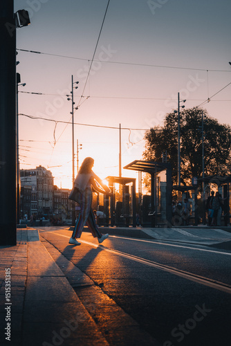 People crossing the street in the sunset
