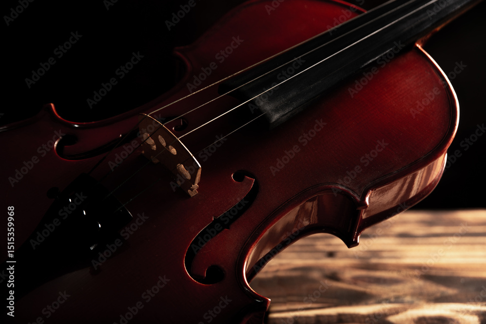 Fototapeta premium Violin, a magnificent violin on rustic wood, abstract background, low key. Selective focus.