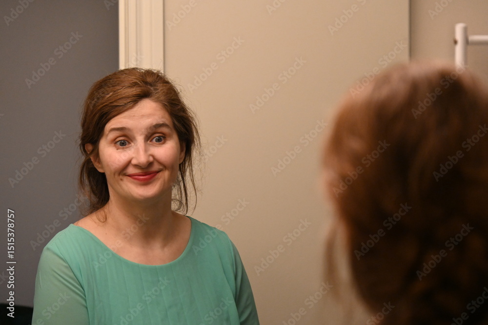 Fototapeta premium woman with lipstick looking in the mirror