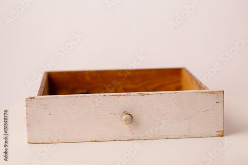 Closeup of a white vintage drawer on a white background