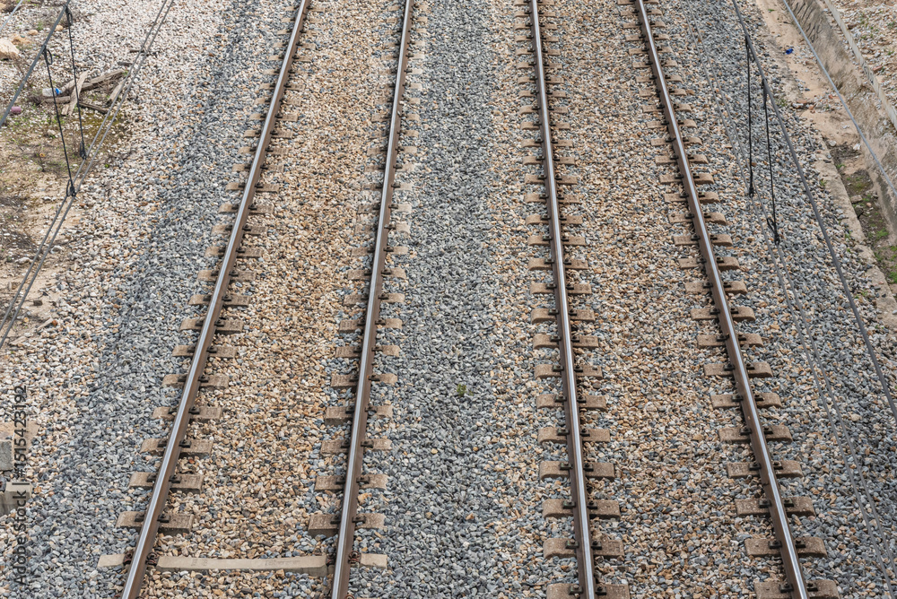 Obraz premium On top of the ballast are sleepers (or ties), cross members that keep the rails at a constant distance and transfer the load from the rails to the ballast.
