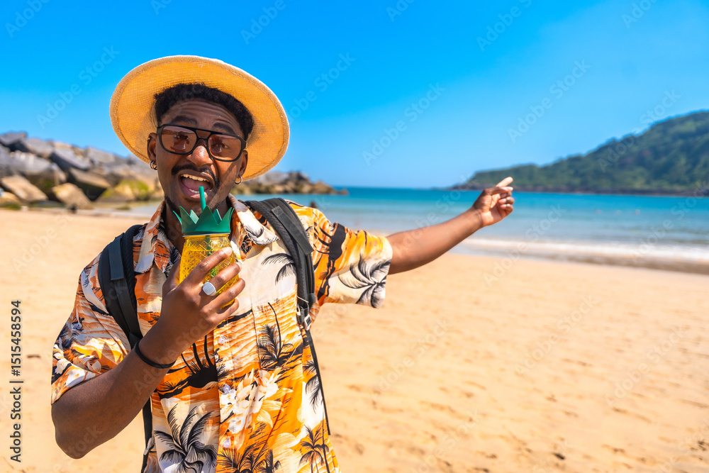 Fototapeta premium Tourist drinking cocktail and pointing at tropical beach