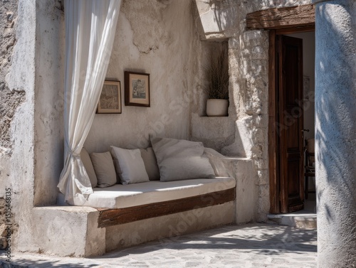 A white bench with a white curtain draped over it. The curtain is covering the bench, creating a cozy and private space. The bench is situated outside, possibly in a courtyard or garden area