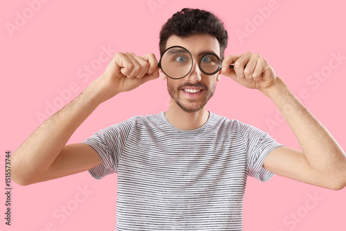 Young man with magnifiers o...