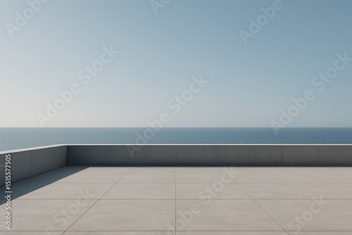 Minimalist empty concrete plaza or viewing platform with a low grey wall overlooking a serene expansive sea view under a vast clear blue sky providing a sense of openness and tranquility.