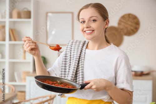 Young housewife holding fry...