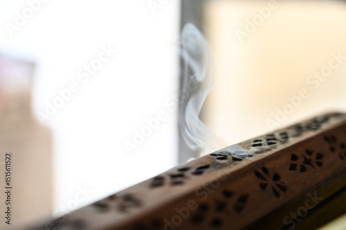 wooden incense burner ,wooden incense box, Wooden Incense Holder with Smoke, Decorative Incense Burner on Table, Aromatic Smoke from Carved Box, incense holder, incense, lit incense, censer