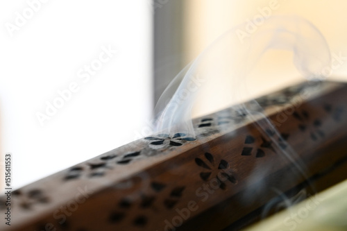 wooden incense burner ,wooden incense box, Wooden Incense Holder with Smoke, Decorative Incense Burner on Table, Aromatic Smoke from Carved Box, incense holder, incense, lit incense, censer