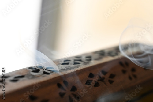 wooden incense burner ,wooden incense box, Wooden Incense Holder with Smoke, Decorative Incense Burner on Table, Aromatic Smoke from Carved Box, incense holder, incense, lit incense, censer