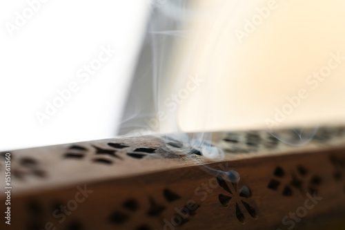 wooden incense burner ,wooden incense box, Wooden Incense Holder with Smoke, Decorative Incense Burner on Table, Aromatic Smoke from Carved Box, incense holder, incense, lit incense, censer