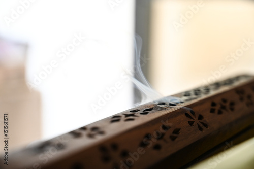 wooden incense burner ,wooden incense box, Wooden Incense Holder with Smoke, Decorative Incense Burner on Table, Aromatic Smoke from Carved Box, incense holder, incense, lit incense,censer