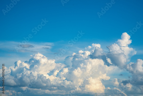 Fotografie Blue sky fluffy white clouds on summer season bright clear skyline with beautiful cloudscape