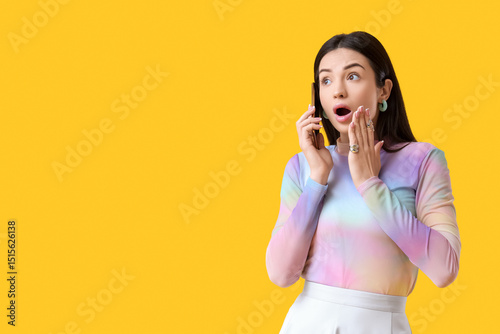 Shocked young woman talking...