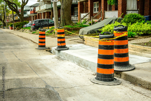 Photography maintaining aging  municipal infrastructure: sidewalk and curb under repair  on