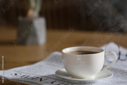 Newspaper with cup of coffe...