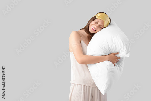 Young woman in pajamas with...