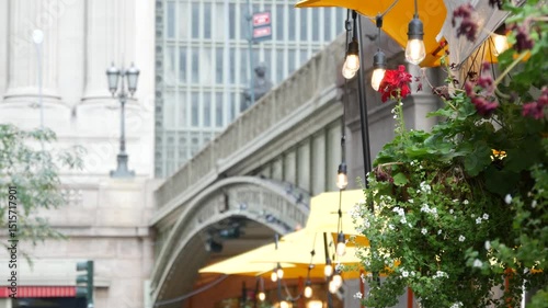 New York City Grand Central Terminal railway station, 42 street. Manhattan Midtown. Bridge on Pershing Square, NYC, USA. American urban scene, United States. Light bulb garland, umbrellas and flowers.