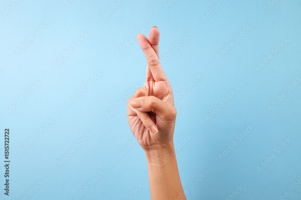 Female Hand Showing Letter R In Sign Language Isolated On Blue Background Female Hand Showing Letter R In Sign Language Isolated On Blue Background