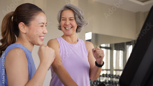 Young active adult child and mature middle age old mum run walk advice workout at gym. Love mental health care older retired mom asia elder people happy protect aging life balance enjoy sport club.